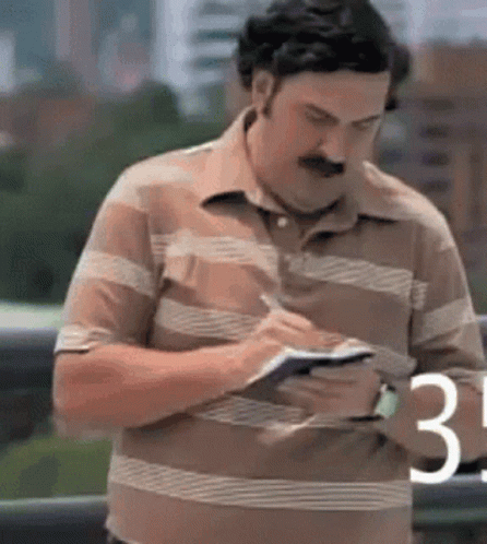 Man in Striped Shirt Writing