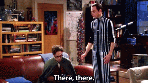 Man In Striped Suit Says There There Beside Man On Couch
