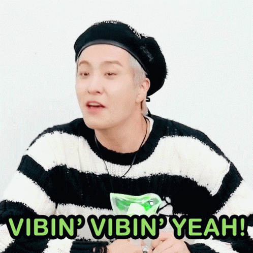 Man in Striped Sweater and Black Hat Saying Vibin Vibin Yeah