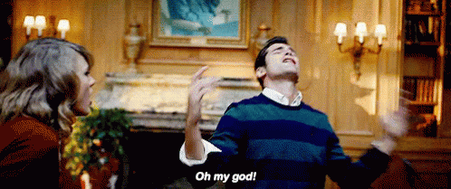 Man in Striped Sweater Saying Oh My God to Woman