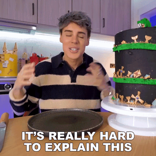 Man In Striped Sweater Says It's Really Hard To Explain In Front Of Cake GIF