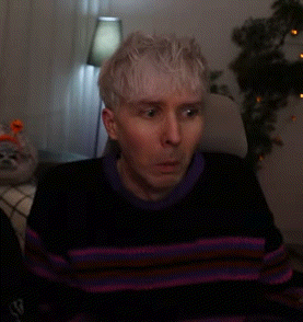 Man in Striped Sweater Sitting in Chair
