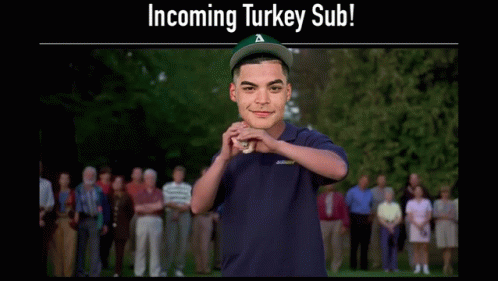 Man in Subway Shirt Holding Turkey Sub