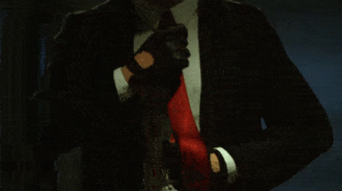 Man in Suit Adjusting Red Tie