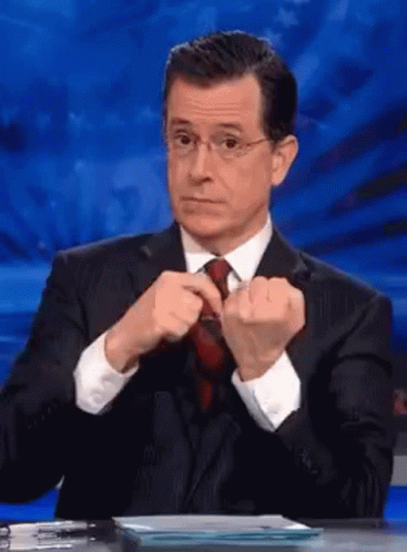 Man in Suit Adjusting Tie