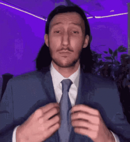 Man in Suit Adjusting Tie