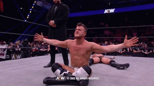 Man in Suit and Another Man in AEW Ring