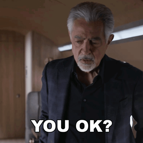 Man in Suit and Black Shirt Says You Ok