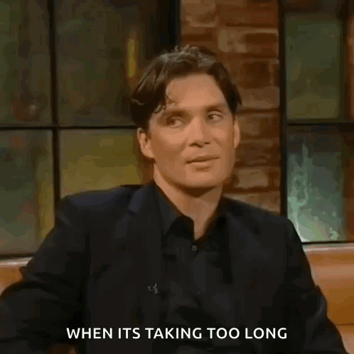 Man in Suit and Black Shirt Talking Brick Wall