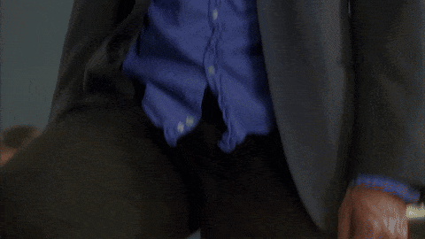 Man in Suit and Blue Shirt Making Face