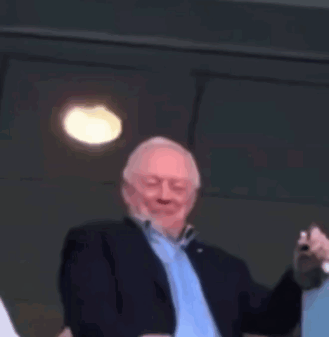 Man in Suit and Blue Shirt Pointing
