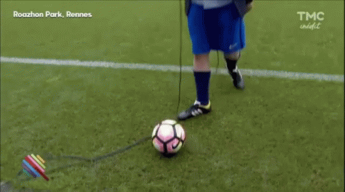 Man in Suit and Blue Shorts on Soccer Field