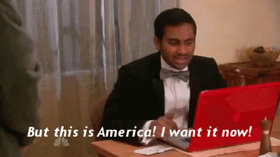 Man in Suit and Bow Tie at Red Laptop Saying But This Is America I Want It Now