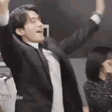 Man In Suit And Bow Tie Dancing Arms Up GIF