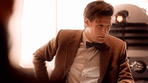 Man in Suit and Bow Tie Looking at Another Man