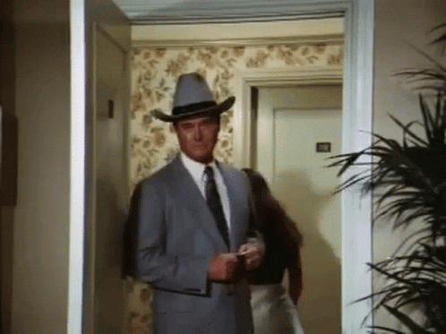 Man in Suit and Cowboy Hat Walking