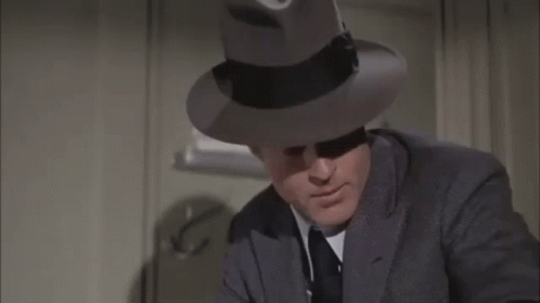 Man in Suit and Fedora Making Funny Face