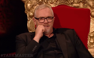 Man in Suit and Glasses in Red Chair Taskmaster