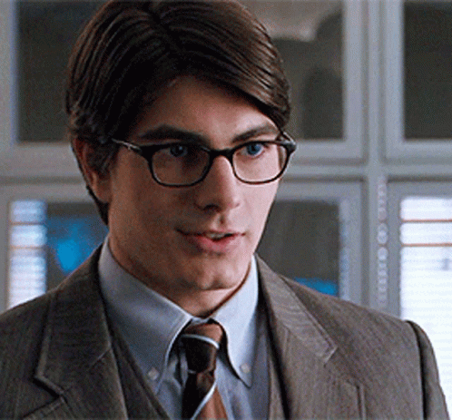 Man in Suit and Glasses Looks at Camera