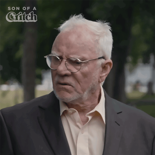 Man in Suit and Glasses Saying Jeez