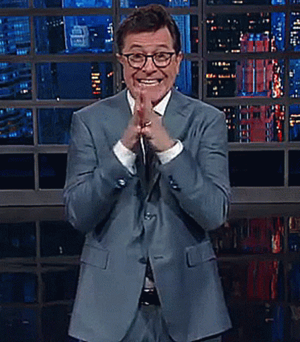 Man in Suit and Glasses Smiling Clapping