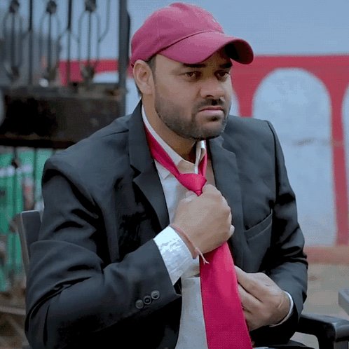 Man In Suit And Hat Adjusting Red Tie GIF