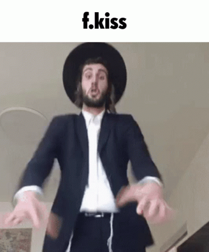 Man in Suit and Hat Dancing with F.Kiss