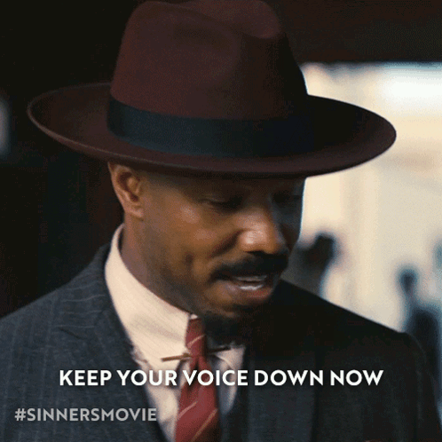 Man In Suit And Hat: Keep Voice Down Now GIF