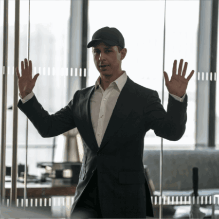 Man In Suit And Hat Standing In Front Of Glass Wall GIF