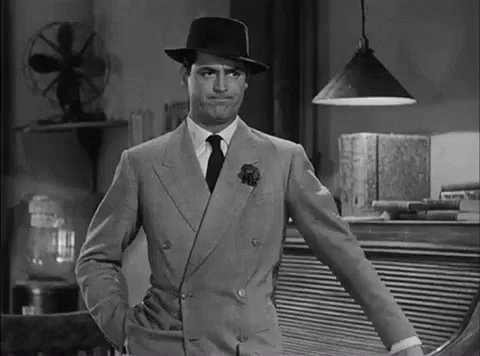 Man in Suit and Hat Standing