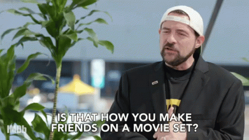 Man in Suit and Hat Talking About Making Friends on Movie Set
