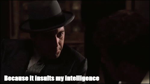 Man in Suit and Hat Talking to Another Man Saying Because It Insults My Intelligence