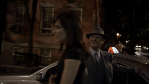 Man In Suit And Hat Talking To Woman GIF