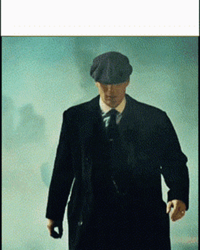 Man in Suit and Hat Walking in Foggy Room
