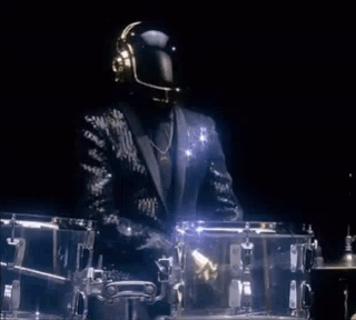 Man in Suit and Helmet at Drum Set