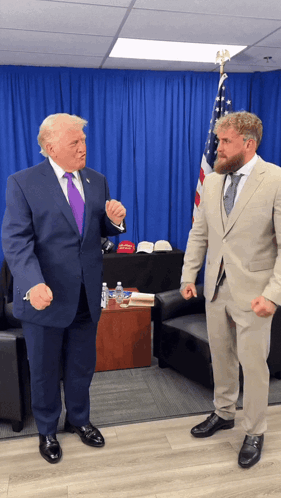 Man In Suit And Man In Tan Suit With American Flag GIF