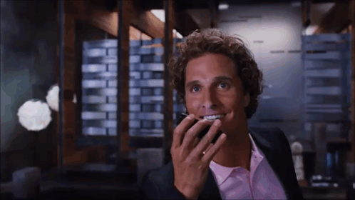 Man In Suit And Pink Shirt Talking On Cell Phone GIF