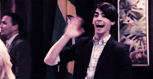 Man In Suit And Plaid Shirt Waving GIF