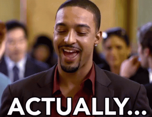 Man in Suit and Red Shirt Laughing Saying Actually