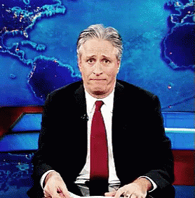 Man In Suit And Red Tie Sitting In Front Of World Map GIF