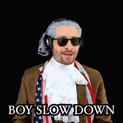 Man in Suit and Scarf Wearing Sunglasses and Headphones