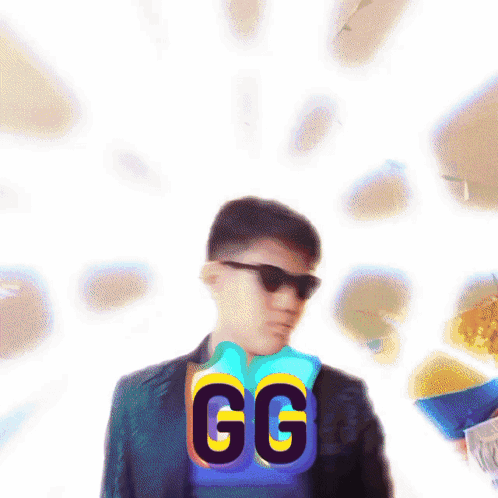 Man in Suit and Sunglasses in Front of GG Sign