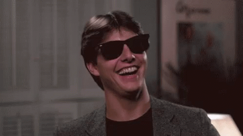 Man in Suit and Sunglasses Laughing and Smiling