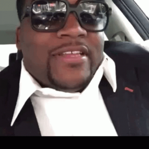 Man in Suit and Sunglasses Smiling