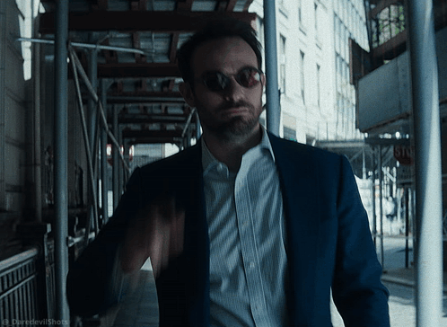 Man in Suit and Sunglasses Walking