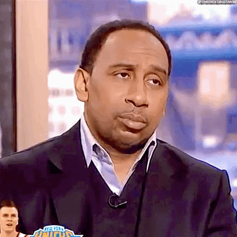 Man in Suit and Sweater on TV Show