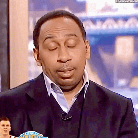 Man in Suit and Sweater on TV Show
