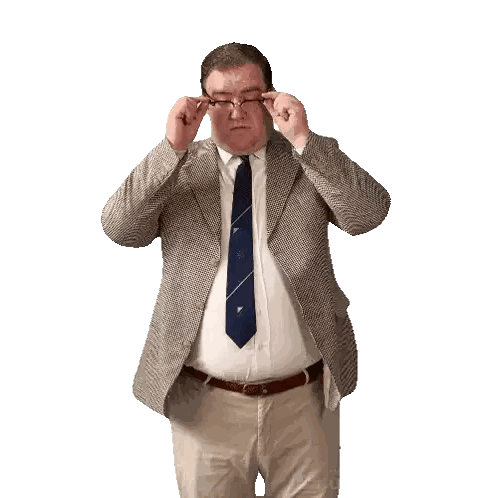 Man in Suit and Tie Adjusts Glasses
