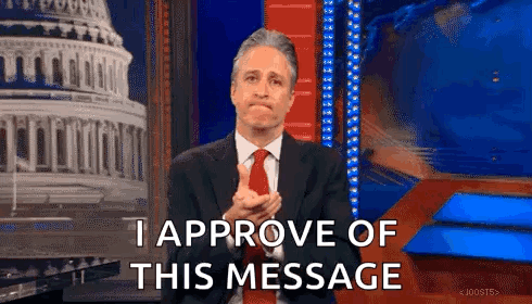Man In Suit And Tie Applauding In Front Of Building GIF