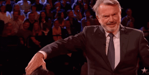 Man In Suit And Tie Arms Outstretched Crowd GIF